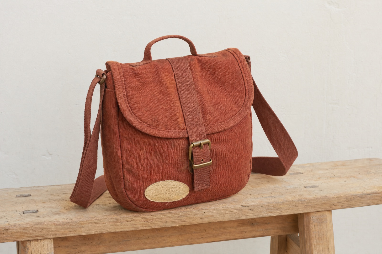Repaired rust canvas bag — R13 attempt 1